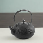 Load image into Gallery viewer, IBILI 40 Oz Cast Iron Teapot with Infuser | Made in Spain | Hammered Texture, Enameled Interior, Stovetop &amp; Induction Compatible, Japanese Kettle for Loose Leaf Tea, Tetsubin Design, Black