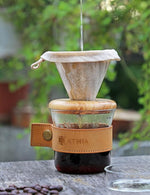 Load image into Gallery viewer, ATHIA glass pour over coffee maker set, minimalist drip coffee maker with reusable cloth filter, glass coffee dripper, olive lid &amp; leather sleeve for single cup manual brewing (Olive Wood)
