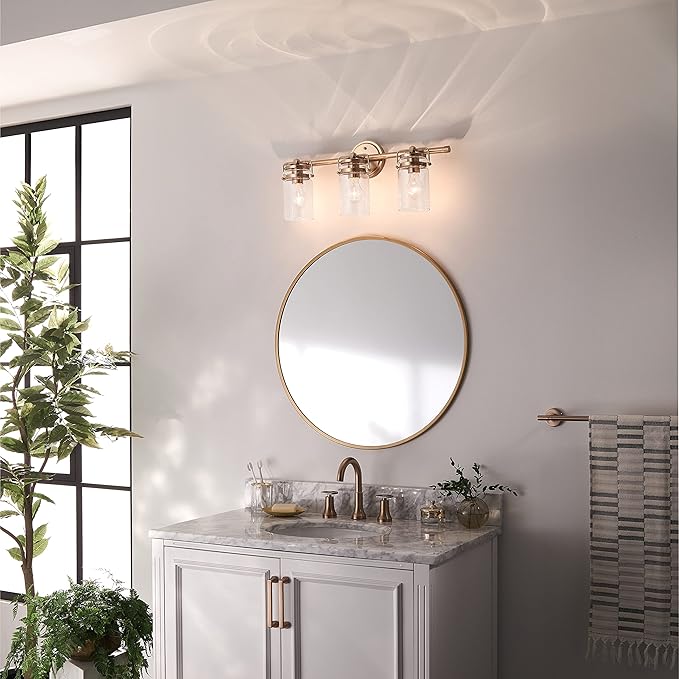 Kichler, Brinley 24" 3 Light Vanity Light with Clear Glass in Champagne Bronze for Bathroom and Powder Room, (24" W x 10.25" H), 45689CPZ