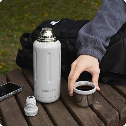 BOBBER 34 oz Stainless Steel Travel Thermos for Hot and Cold Drinks – Dishwasher Safe Metal Water Bottle with Cup Lid – Keeps Hot for 48 Hours – BPA-Free, Vacuum Insulated (Sand Grey)